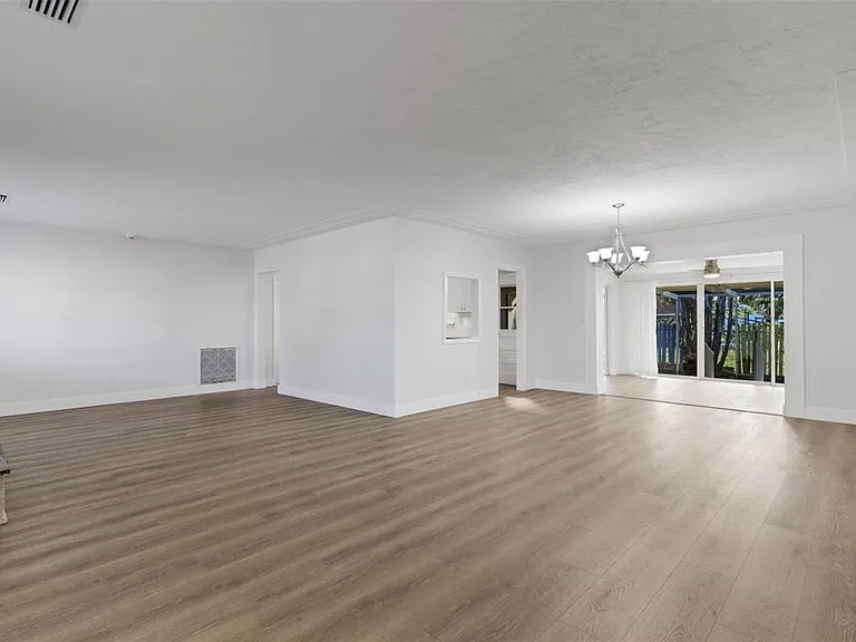 Luxury vinyl plank (LVP) flooring installation in a living and dining area in St. Pete Beach, FL