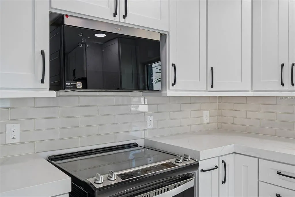 Tile backsplash installation in a white kitchen in Treasure Island, FL