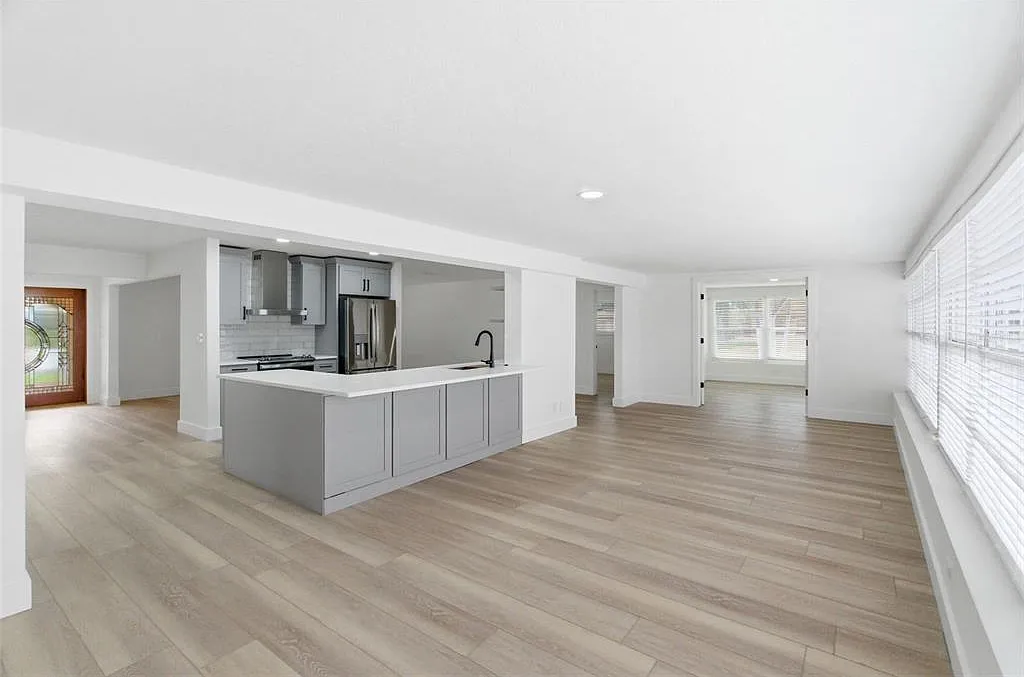 Wood-look porcelain tile flooring installation in an open-concept living area in St. Pete Beach, FL