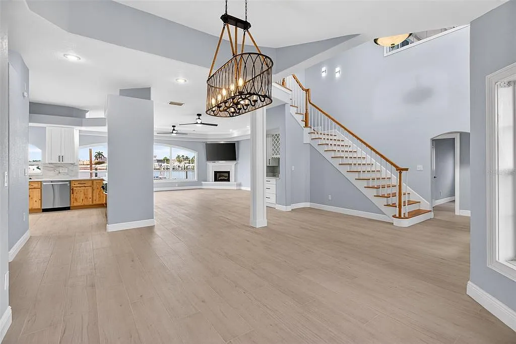 Wood-look porcelain tile flooring in a two-story great room with staircase in St. Petersburg, FL